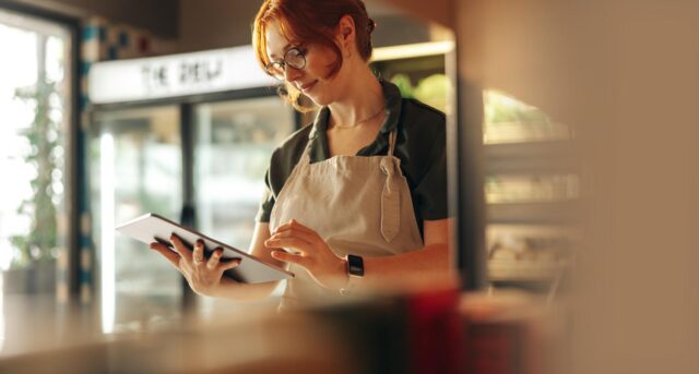 Small business owner adds a digital business receipt to an ipad
